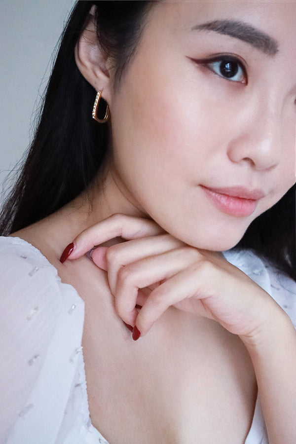 Asian model wearing elegant cz hoop earrings