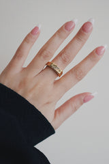 Woman in black wearing the trend statement cz gold ring