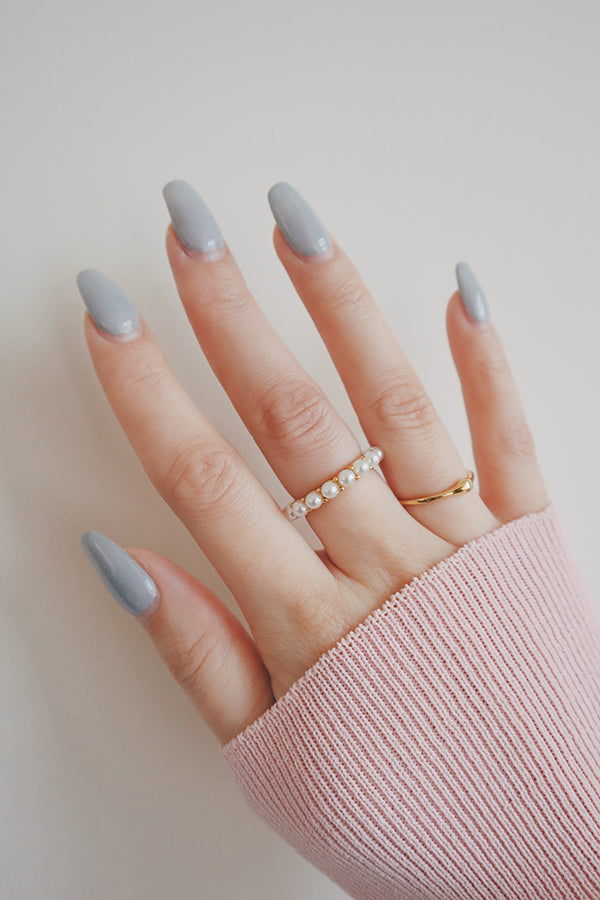 Model in pink wearing an elegant pearl ring for wedding outfit