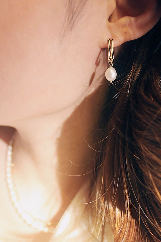 Pearl earrings under spotlight