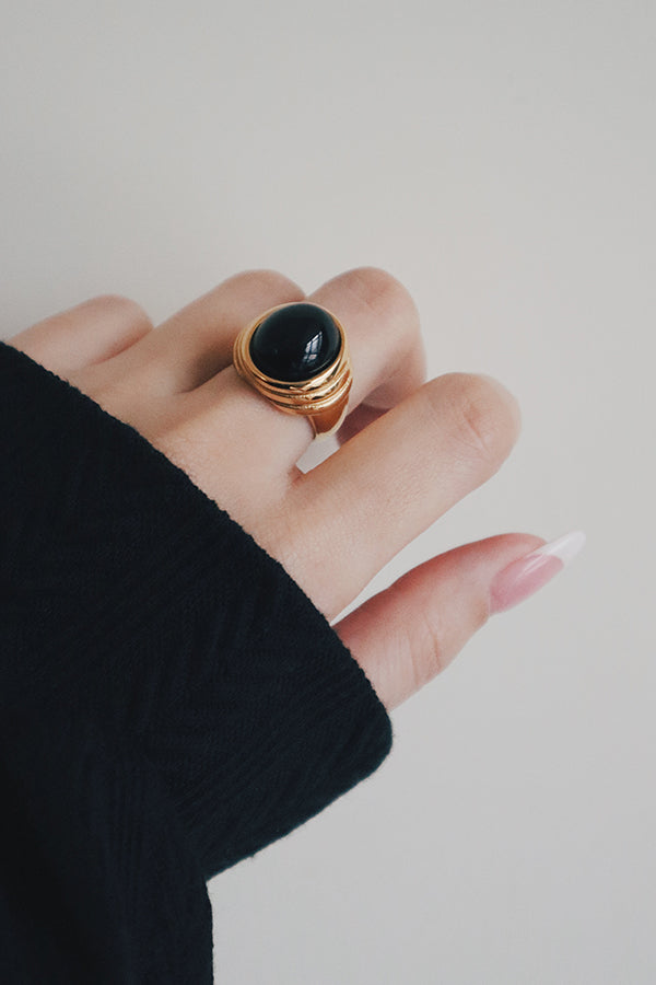 Woman wearing a hypoallergenic gemstone ring for party outfit