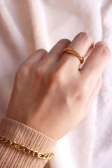 Model wearing SH&Co. jewelry gold ring on the middle finger