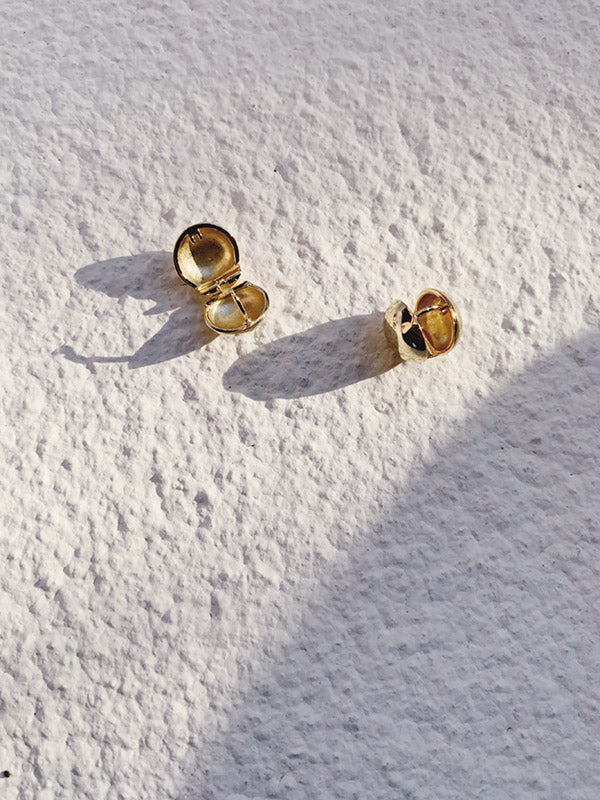 A pair of gold round small studs
