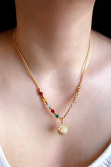 Woman wearing cute colorful beats and opal sun necklace