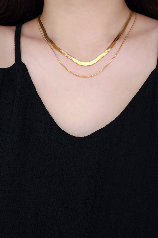 Model wearing herringbone necklace under the spotlight