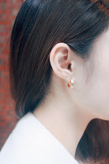 Dainty gold semi circle hoops with red on the inside