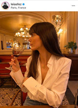 Gold necklace in bar having drinks with white shirt