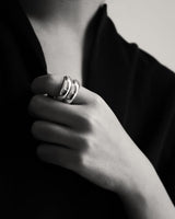 Black and white shot of woman posing for stacked rings