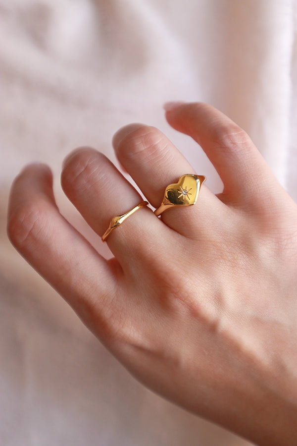 Woman wearing the cz heart shape ring and dainty gold ring