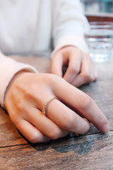 Hand model with slim topaz ring with many bitsy topaz on it
