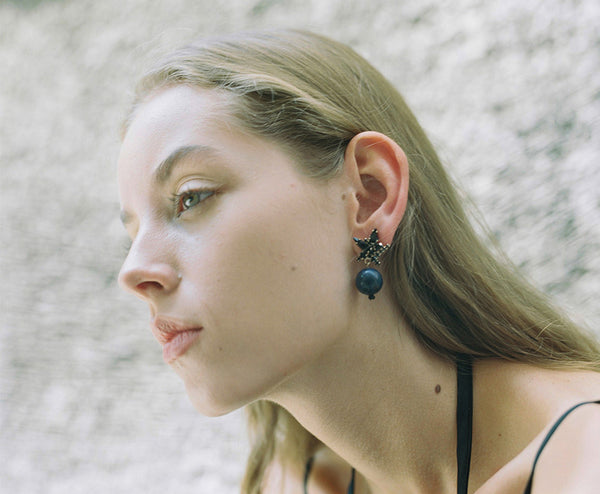 Model wearing lapis lazuli shiny earrings