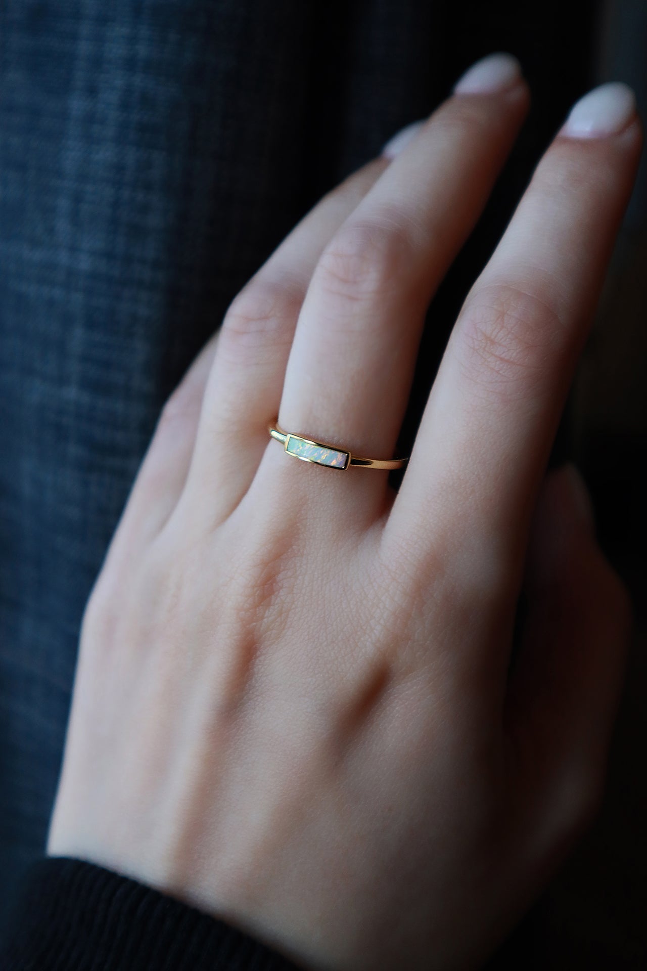 Close shot of opal slim golg ring on middle finger
