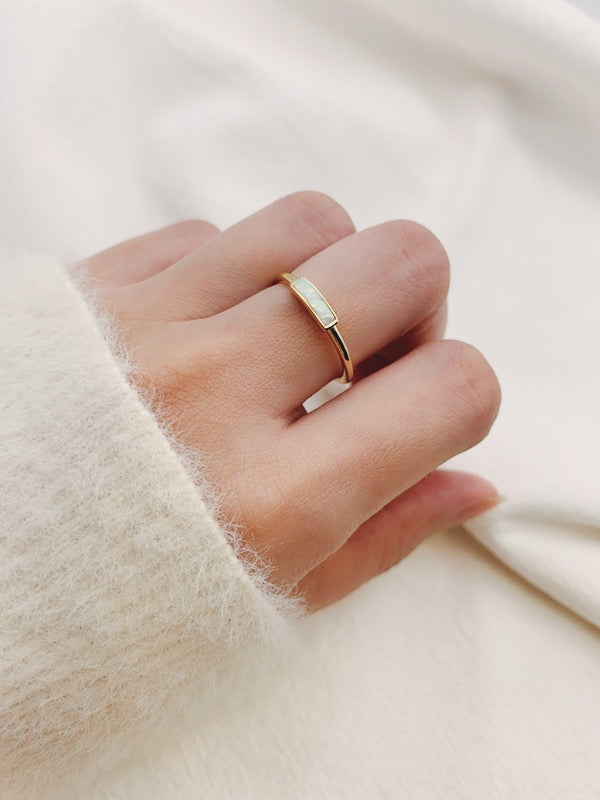 White sweater with dainty opal ring from SH & Co.