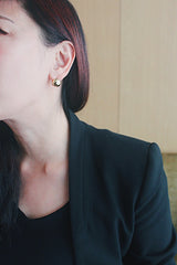 Jessica wears spherical gold earrings from SH & Co.