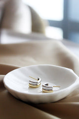 Duo tone gold and silver hoops on a ceramic plate