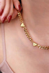 Model holding the layering necklace shows to the camera
