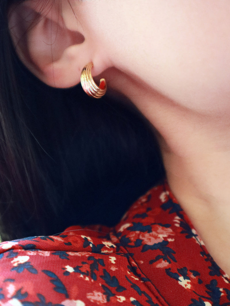 Black hair model wearing 14K gold earring