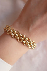 Model wearing a stainless steel gold plated bracelet on her wrist