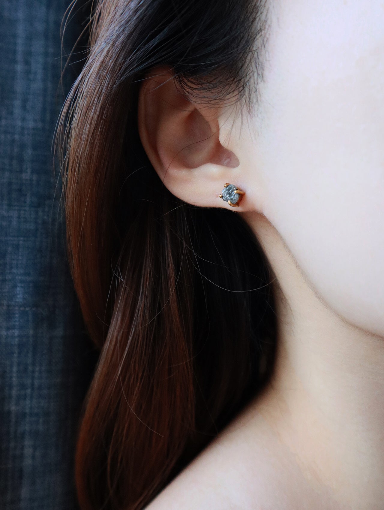 Close shot of women wearing raw Herkimer earrings