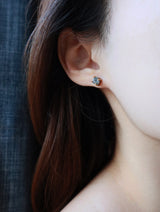Close shot of women wearing raw Herkimer earrings