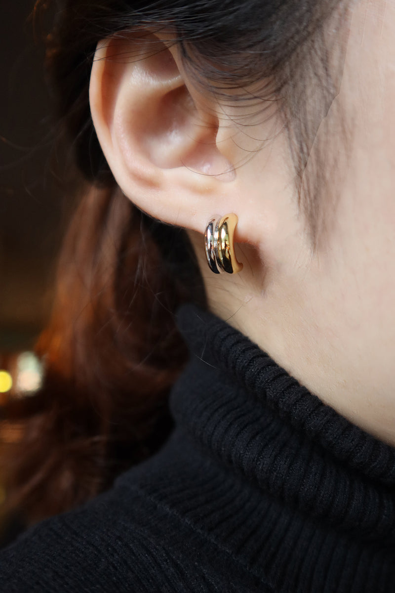 Women hearing duo tone hoops showing half her face